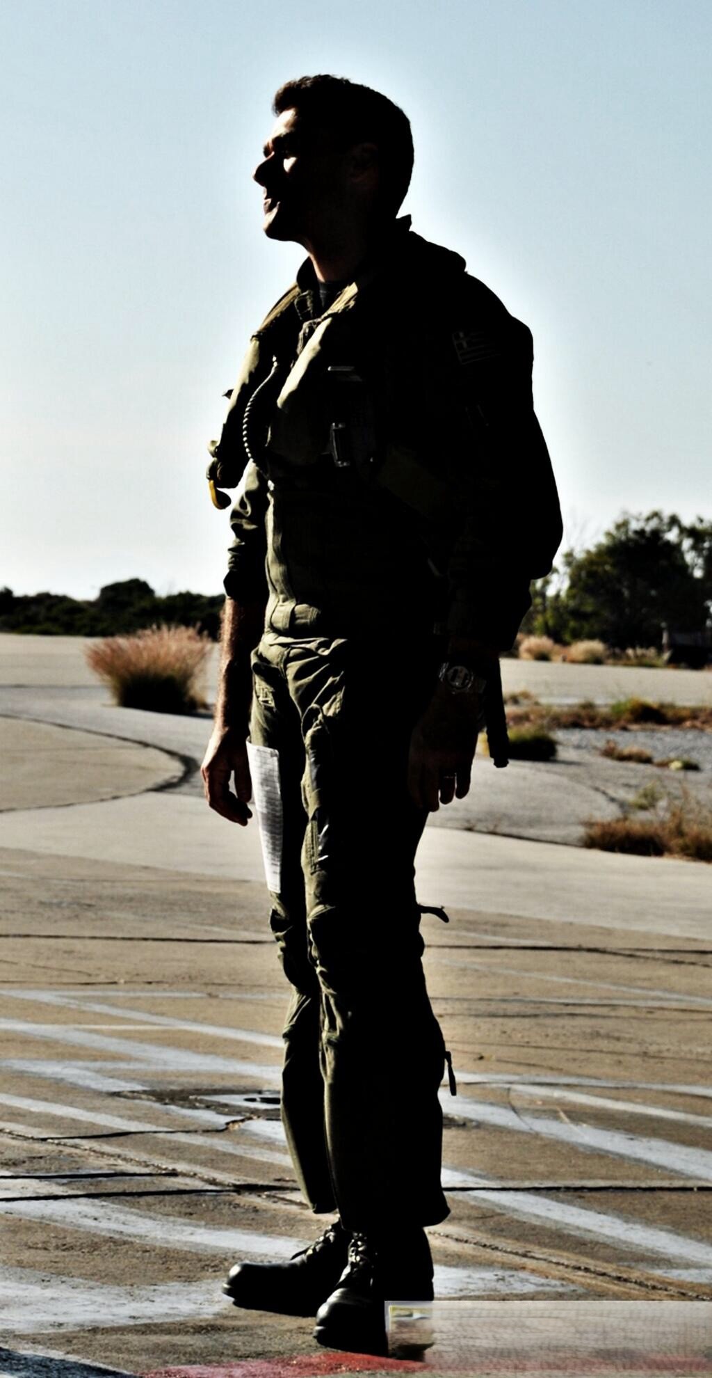 Manolis Karachalios in a flight suit on an airfield